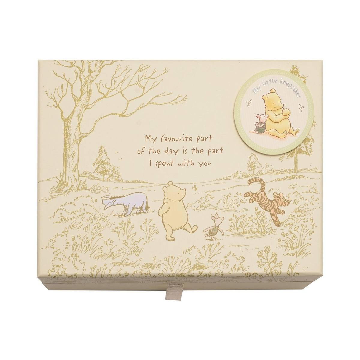 Cream rectangular keepsake box printed with Pooh, Piglet, Eeyore and Tigger in a meadow scene, a round "My little keepsakes" badge, and a favourite-day quote, shown on a white background.