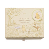 Cream rectangular keepsake box printed with Pooh, Piglet, Eeyore and Tigger in a meadow scene, a round "My little keepsakes" badge, and a favourite-day quote, shown on a white background.