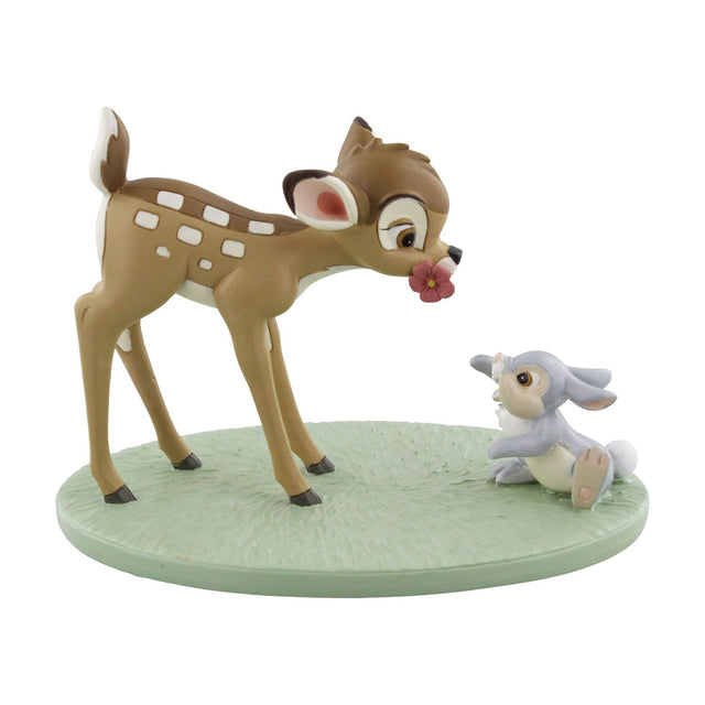 Hand-painted Bambi & Thumper figurine on an oval green base, Bambi in spotted brown with a flower on his nose beside grey-cream Thumper, on a plain white background.