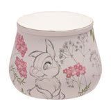Round white ceramic trinket box with lid featuring a pencil-sketch Thumper rabbit among pink flowers and grey wildflowers, speckled gloss finish, on a plain white background.