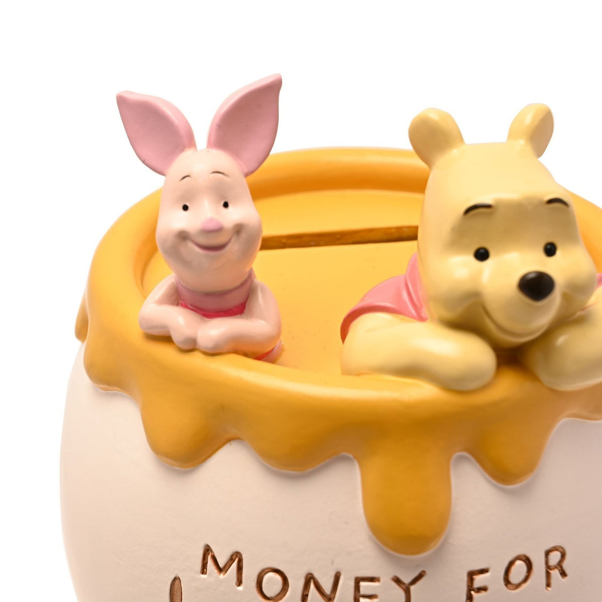 Resin honey pot money box in white with dripping honey-yellow rim, featuring Winnie the Pooh and Piglet figures peeping over the edge, engraved "Money for Hunny" text, on a plain white background.