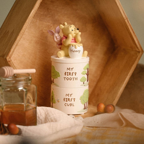 Winnie the Pooh Tooth & Curl Resin Keepsake Box Set, two stacked round white boxes reading My First Tooth and My First Curl, with Pooh and Piglet atop a Hunny pot lid.