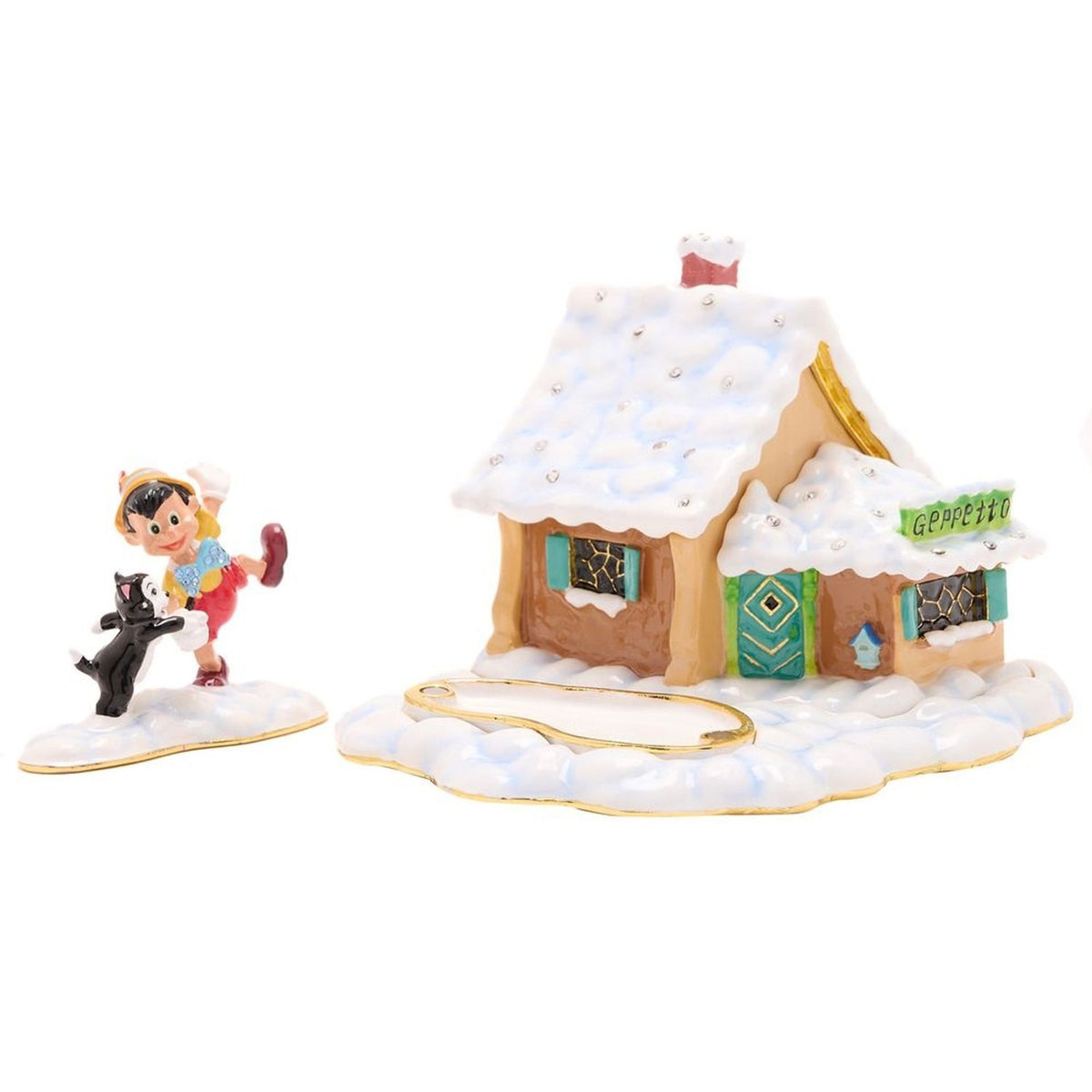 Pinocchio and Figaro Cottage Scene metal trinket box featuring a snow-covered tan cottage with teal shutters and door, red chimney, and a separate Pinocchio and Figaro figure.