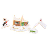 Metal trinket box featuring a snow-covered cottage with tan walls, teal shutters and door, red chimney, a Geppetto sign, and Pinocchio with Figaro figures nearby.