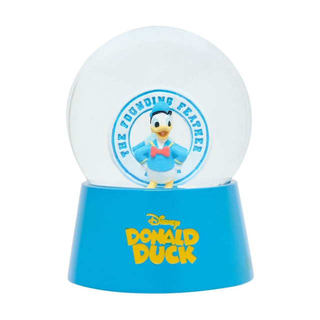 Resin snow globe with a Donald Duck sailor figure in blue cap and red bow tie inside a clear dome, set on a blue base reading "Disney Donald Duck," plain white background.