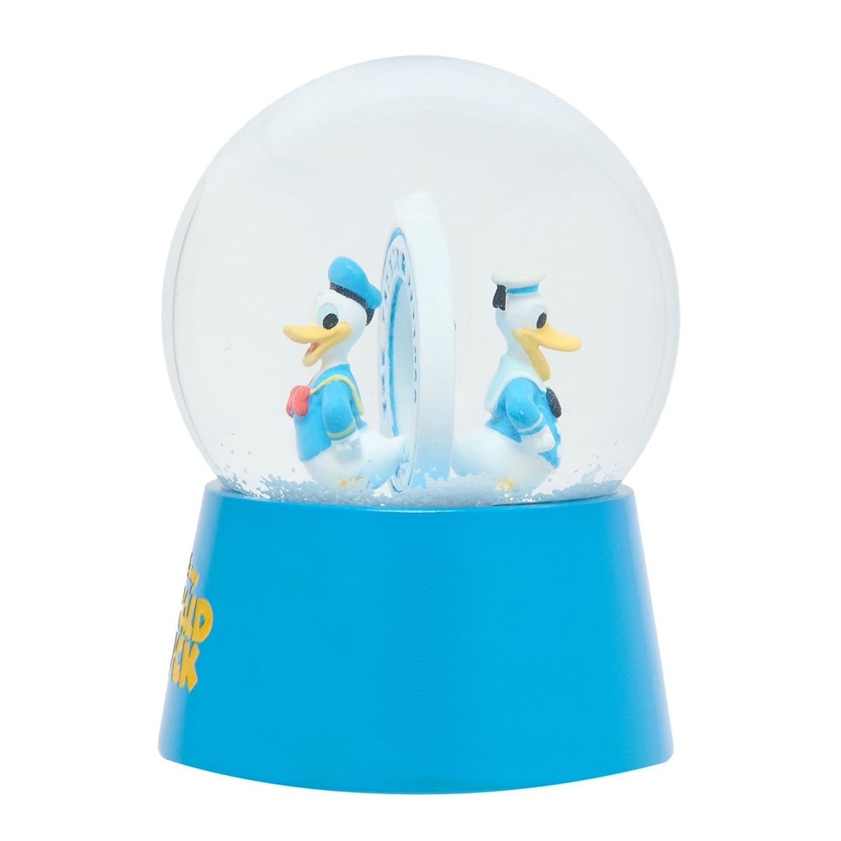 Resin snow globe with twin Donald Duck sailor figures in blue and white outfits standing back to back around a white disc, set on a blue base against a plain background.