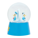 Resin snow globe with twin Donald Duck sailor figures in blue and white outfits standing back to back around a white disc, set on a blue base against a plain background.