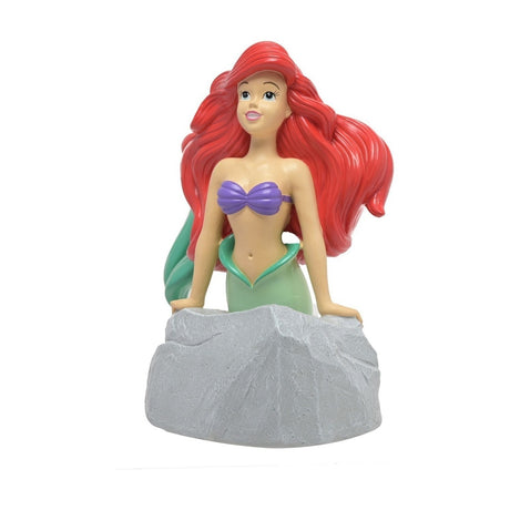 Ariel Mermaid Leaning on Rock Resin Money Box, featuring red hair, purple shell top, green tail, grey textured rock base with coin slot, on a plain white background.