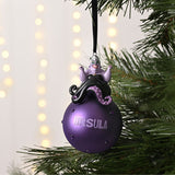 Ursula on Glass Bauble Christmas Tree Decoration in purple, with figure perched atop a studded round bauble reading "URSULA", hung from a black ribbon on a Christmas tree.