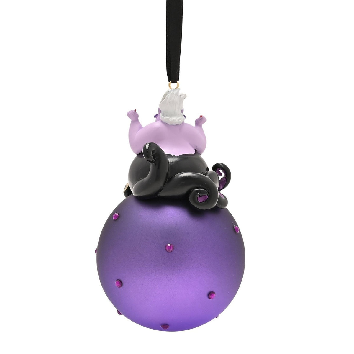 Glass Christmas bauble ornament featuring Ursula with white hair and black tentacles seated atop a round purple bauble studded with small purple gems, hung from a black ribbon on a white background.
