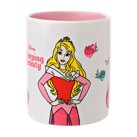 White gloss stoneware mug with pink interior and handle, featuring Disney's Sleeping Beauty Aurora with hands on hips and the three fairies, 325ml, on a plain background.