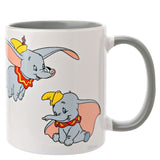 White stoneware Dumbo Elephant mug with grey handle and grey interior glaze, showing a flying Dumbo with a mouse on his hat and a seated Dumbo with trunk raised, on a plain white background.