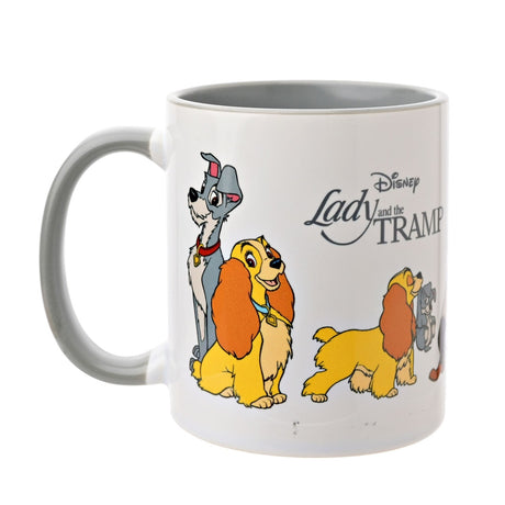 White stoneware mug with grey handle and interior, featuring Lady and the Tramp characters and logo text on a glossy white body, shown on a plain white background.