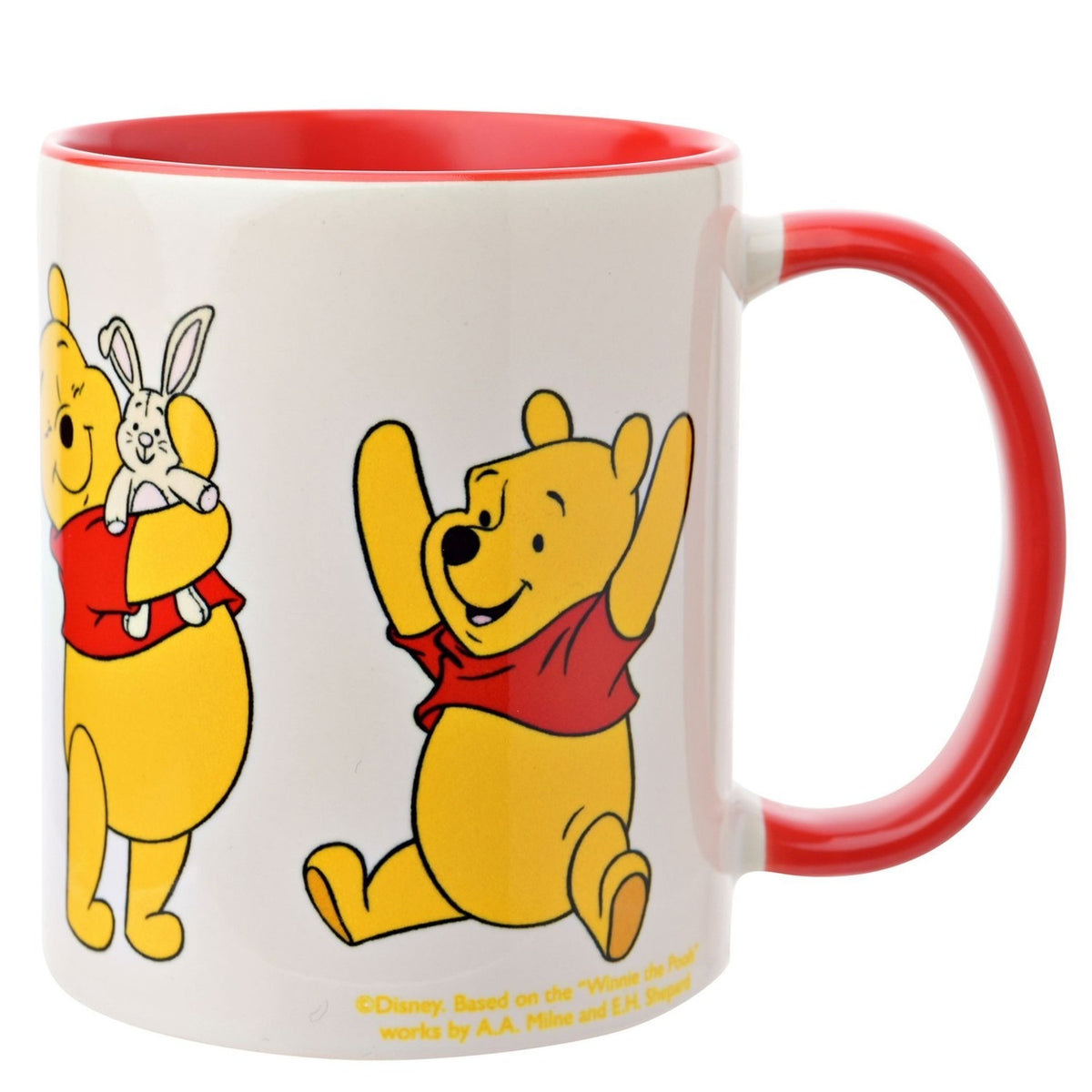 White stoneware Winnie the Pooh mug, 325ml, with red handle and interior, showing Pooh holding a toy rabbit and raising his arms, on a plain white background.
