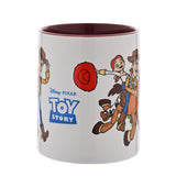 White stoneware mug with burgundy interior, printed with Woody and Jessie on horseback and standing poses, plus Toy Story logo, 325ml, plain background.