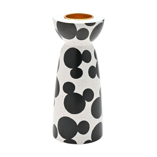 Ceramic tealight candle holder with scattered black Mickey Mouse head shapes on a white speckled finish, rounded cup with gold-coloured insert, narrow waist and tapered base, on a plain background.