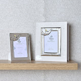 Dumbo Photo Album with silver metal Dumbo frame and grey cover, holding a 6 x 4in photo, shown beside a smaller matching Disney Baby photo frame on a wooden shelf.