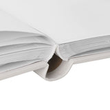 Close-up of the Dumbo Photo Album's grey cover showing bound white pages and cream spine binding with visible stitching, photographed on a plain background.