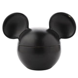 Mickey Mouse ceramic vessel scented candle in matt black, shaped like Mickey's head with lidded ears, on a plain white background.