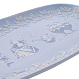 Soft blue glazed earthenware serving plate featuring Queen of Hearts, White Rabbit with trumpet, and Tweedledum and Tweedledee in white and blue line art with a rose-vine border.