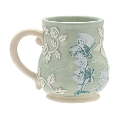 Green earthenware mug with embossed rose and leaf details, printed Mad Hatter design, 10/6 hat card, cream handle, and partial lettering "You can always take", on a white background.