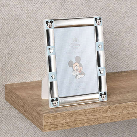Silver-plated 6 x 4in photo frame with colour Mickey Mouse faces at each corner and light blue side panels featuring Mickey silhouettes and stars.