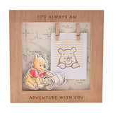 Square wooden box photo frame in brown featuring a raised Winnie the Pooh cut-out, a Hundred Acre Wood map backdrop, and mini pegs holding a blank photo card.