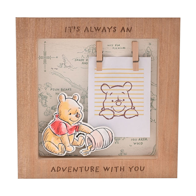 Square wooden box photo frame in brown featuring a raised Winnie the Pooh cut-out, a Hundred Acre Wood map backdrop, and mini pegs holding a blank photo card.