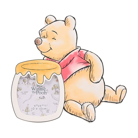 Winnie the Pooh shaped wooden photo frame in orange and white, sketch-style design with Pooh in a red top beside a honey pot photo opening, shown on a plain white background.