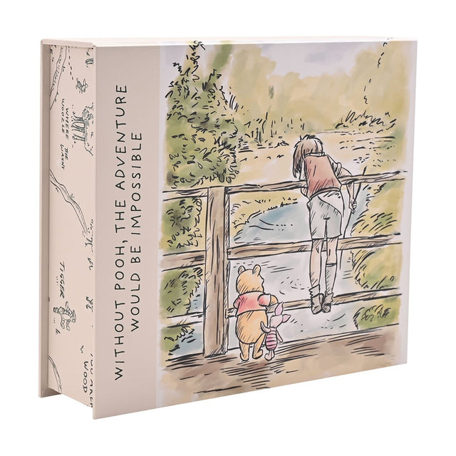Cream rectangular Winnie the Pooh keepsake box featuring a watercolour print of Pooh, a friend and a boy at a wooden bridge, with spine text "Without Pooh, the adventure would be impossible."