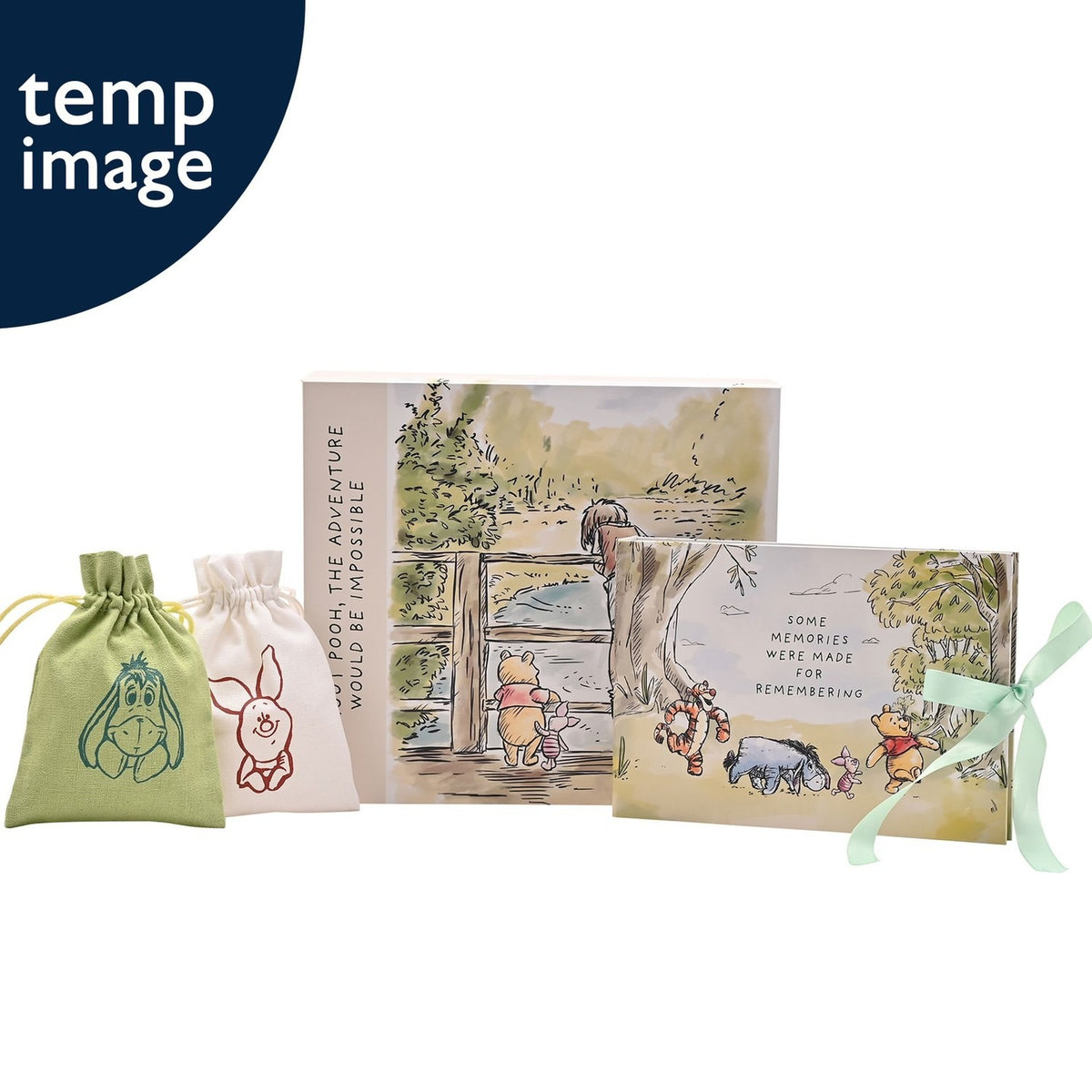 Winnie the Pooh cream rectangular keepsake box with watercolour bridge scene, paired photo album, and two drawstring bags featuring Eeyore and Piglet designs on a white background.