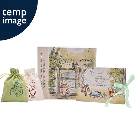 Winnie the Pooh cream rectangular keepsake box with watercolour bridge scene, paired photo album, and two drawstring bags featuring Eeyore and Piglet designs on a white background.