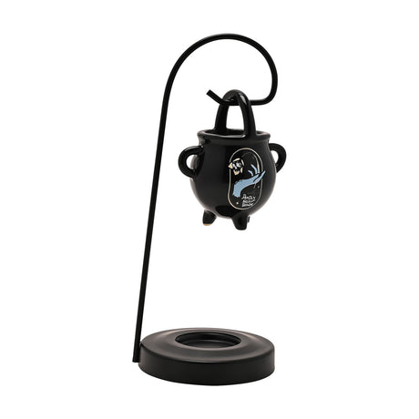 Black ceramic wax melt burner shaped like a cauldron with a pale blue hand design, hung from a tall curved black stand on a round base, plain white background.