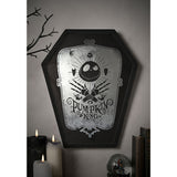 Coffin-shaped black wooden wall plaque with mirrored centre featuring Jack Skellington's skull, crossed skeletal hands, and "Pumpkin King" text, shown mounted on a wall above candles and books.