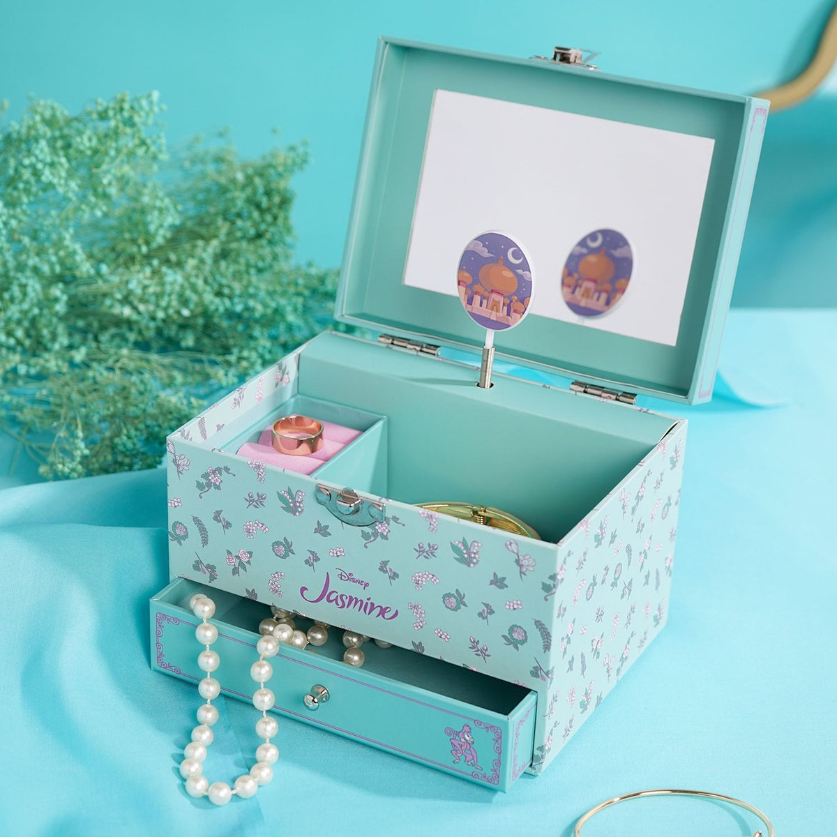 Pastel Princess Jasmine Musical Jewellery Box in mint with floral print, open to reveal a mirror, spinning figure, ring tray and pull-out drawer with pearl necklace.