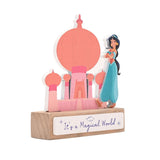 Wooden standing plaque of Princess Jasmine beside a pastel coral and pink palace silhouette with onion domes, on a wood block base reading "It's a Magical World," shown on a white background.