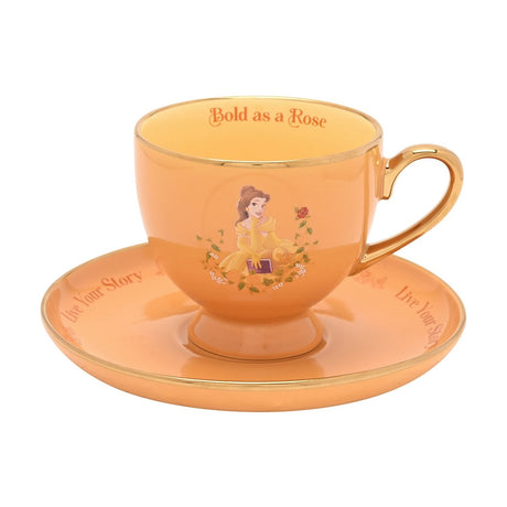 Yellow porcelain footed tea cup and saucer with gold trim, featuring Belle in her gown, Bold as a Rose on the rim, and Live Your Story on the saucer.