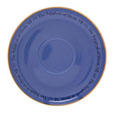 Purple porcelain saucer with gold rim, repeating "The Kindest of them All" script and floral motifs around the border, on a plain white background.