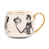 Cream porcelain mug with gold handle featuring black sketched Jack and Sally artwork and gold "Jack & Sally" lettering below the rim, shown on a plain white background.