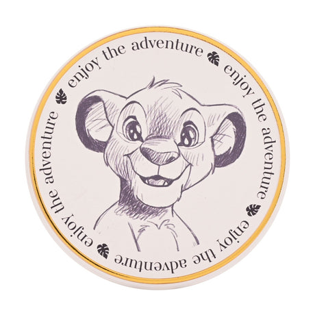 Round white stoneware coaster with a grey pencil-sketch illustration of Simba as a cub, bordered by a gold-tone rim and repeated "enjoy the adventure" text, shown on a plain background.