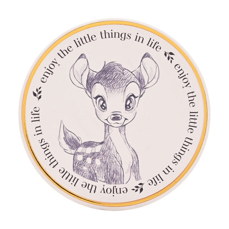 Round white stoneware coaster with a gold rim, featuring a pencil-sketch of Bambi and "enjoy the little things in life" repeated around the edge, on a plain background.