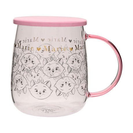 Clear glass mug with pink tint and pink lid, featuring repeated grey sketched Marie cat face prints and gold "Marie" lettering with hearts around the rim, pink handle, on a white background.