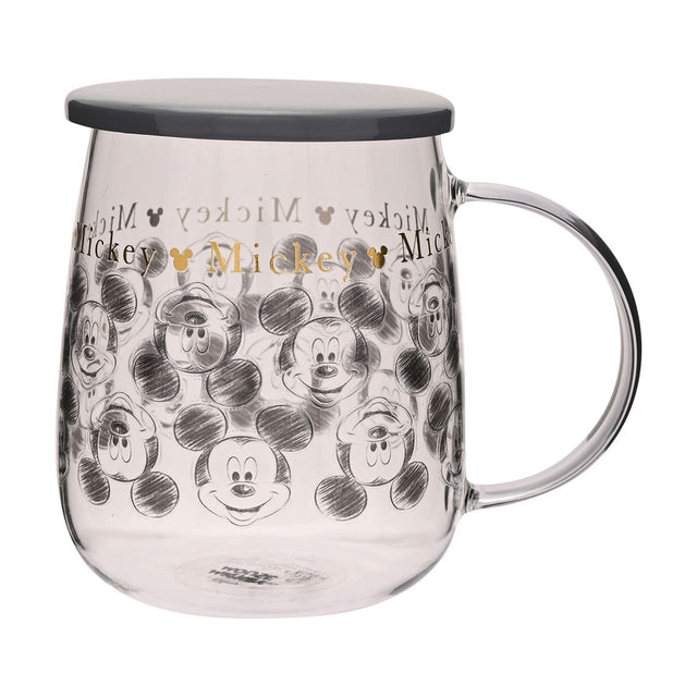 Mickey Mouse Classic Collectable Glass Mug with Lid in Grey, featuring sketch-style Mickey faces and gold "Mickey" text, with a clear handle and grey lid, shown on a white background.