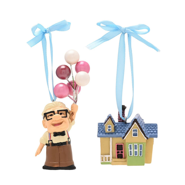 Set of 2 resin hanging Christmas decorations: Carl figurine holding pink, white and plum balloons, paired with his multicoloured house, each on a blue ribbon, on a white background.
