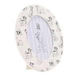 Oval wooden photo frame in white with sketched black dog illustrations around the border, featuring a 6 x 4in oval opening and inner stripe mat, shown on a plain background.
