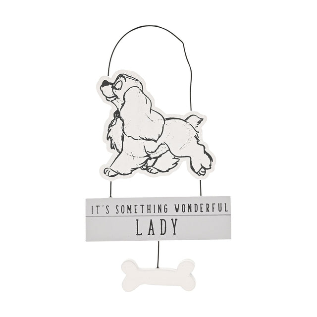 Small white wooden hanging plaque with black line-drawn Lady from Lady and the Tramp, grey sign reading "IT'S SOMETHING WONDERFUL LADY", wire hanger and wooden bone charm, on a plain white background.