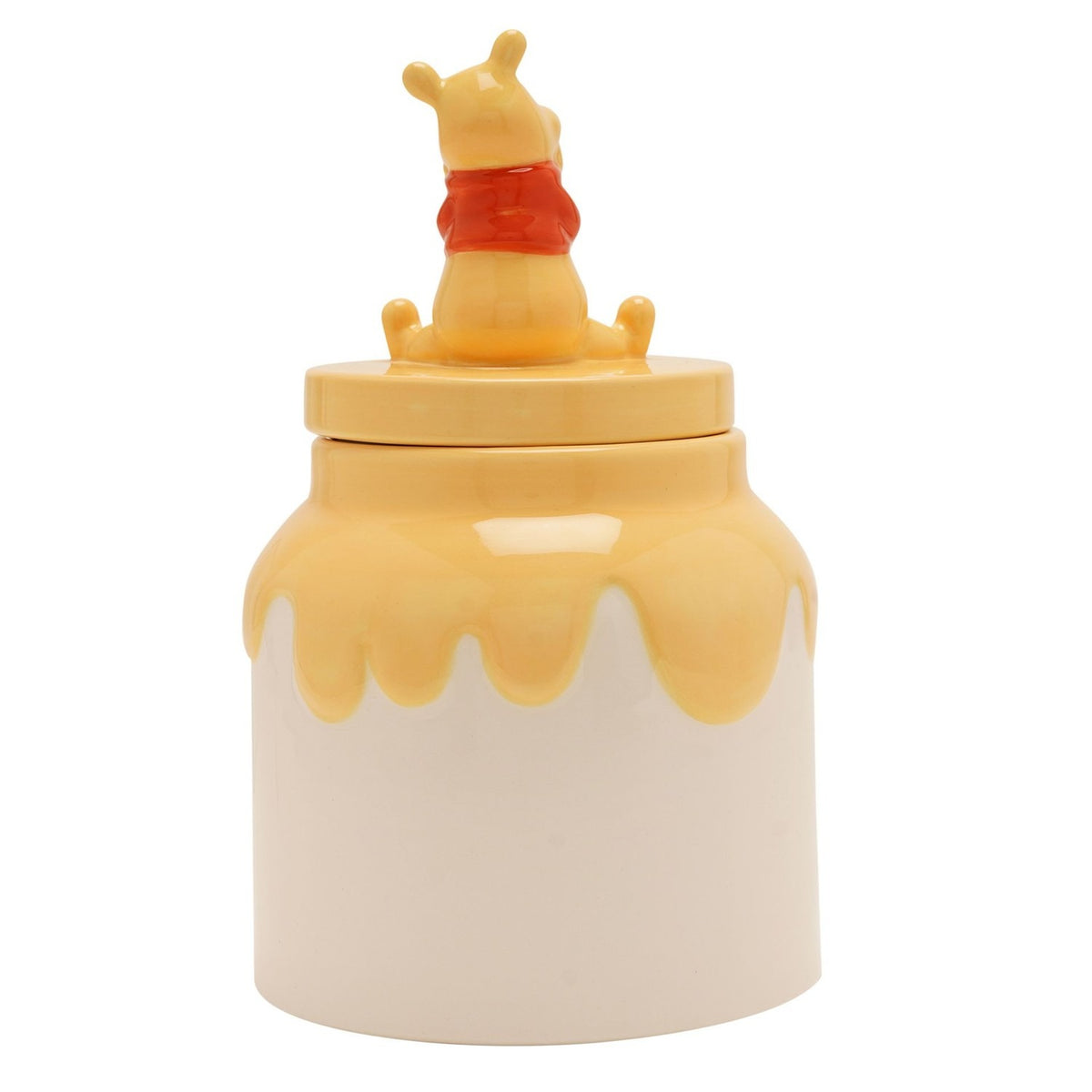 Ceramic honey pot storage jar with Winnie the Pooh seated on the lid, glossy yellow drip over a cream body, shown from behind on a plain white background.