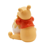 Rear view of the Winnie the Pooh Honey Pot resin storage box, showing the pale yellow bear in a red top sitting beside a white honey pot, on a plain background.