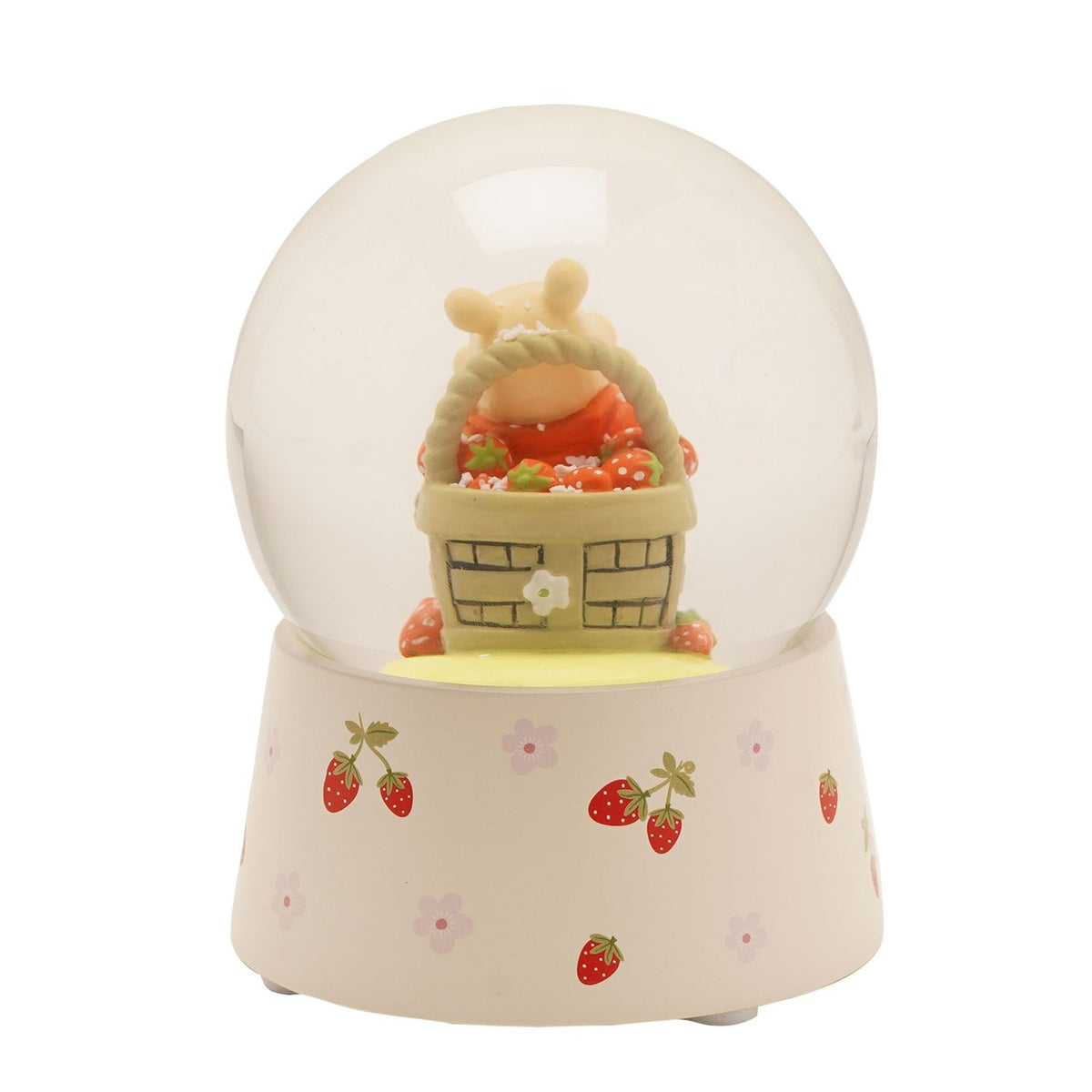 Winnie the Pooh snow globe featuring a figure peeking from a woven strawberry basket inside a clear glass globe, set on a cream base with strawberry and floral accents.