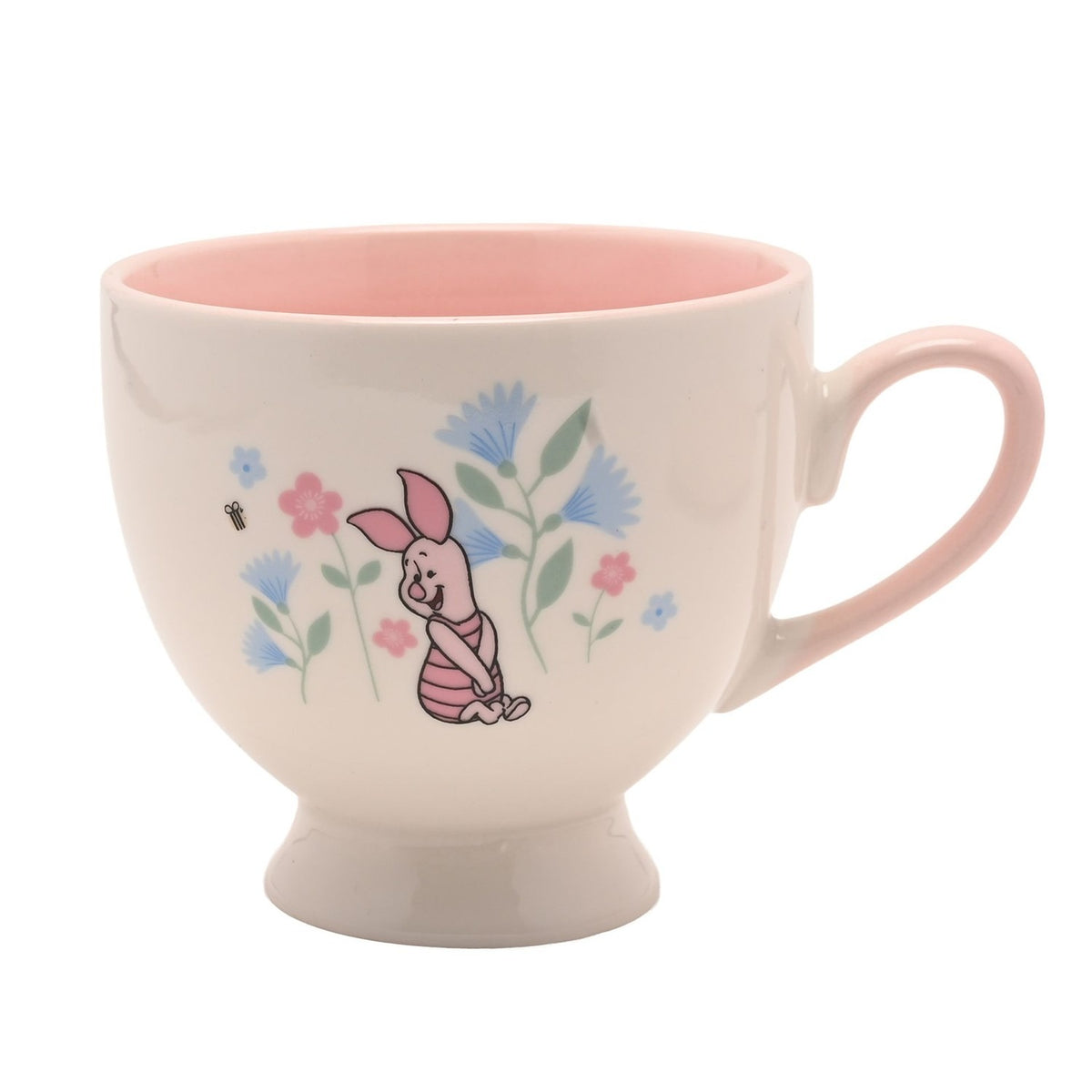 Porcelain footed teacup with pink handle and pink interior, cream exterior printed with Piglet and blue and pink floral stems, on a plain white background.